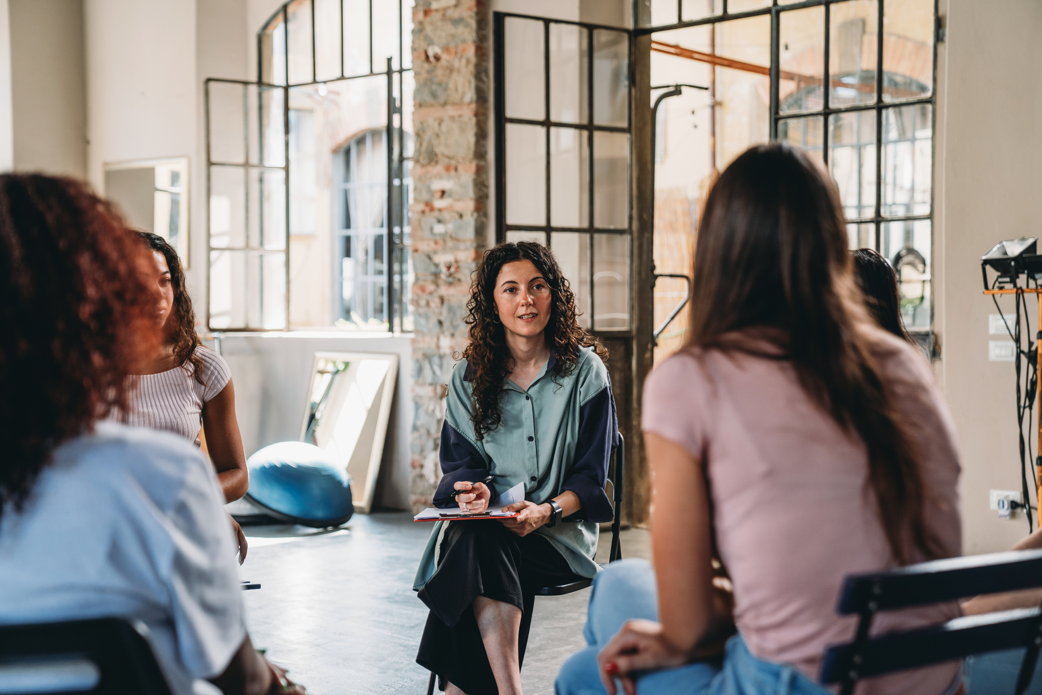 A substance abuse counselor leads a group therapy session