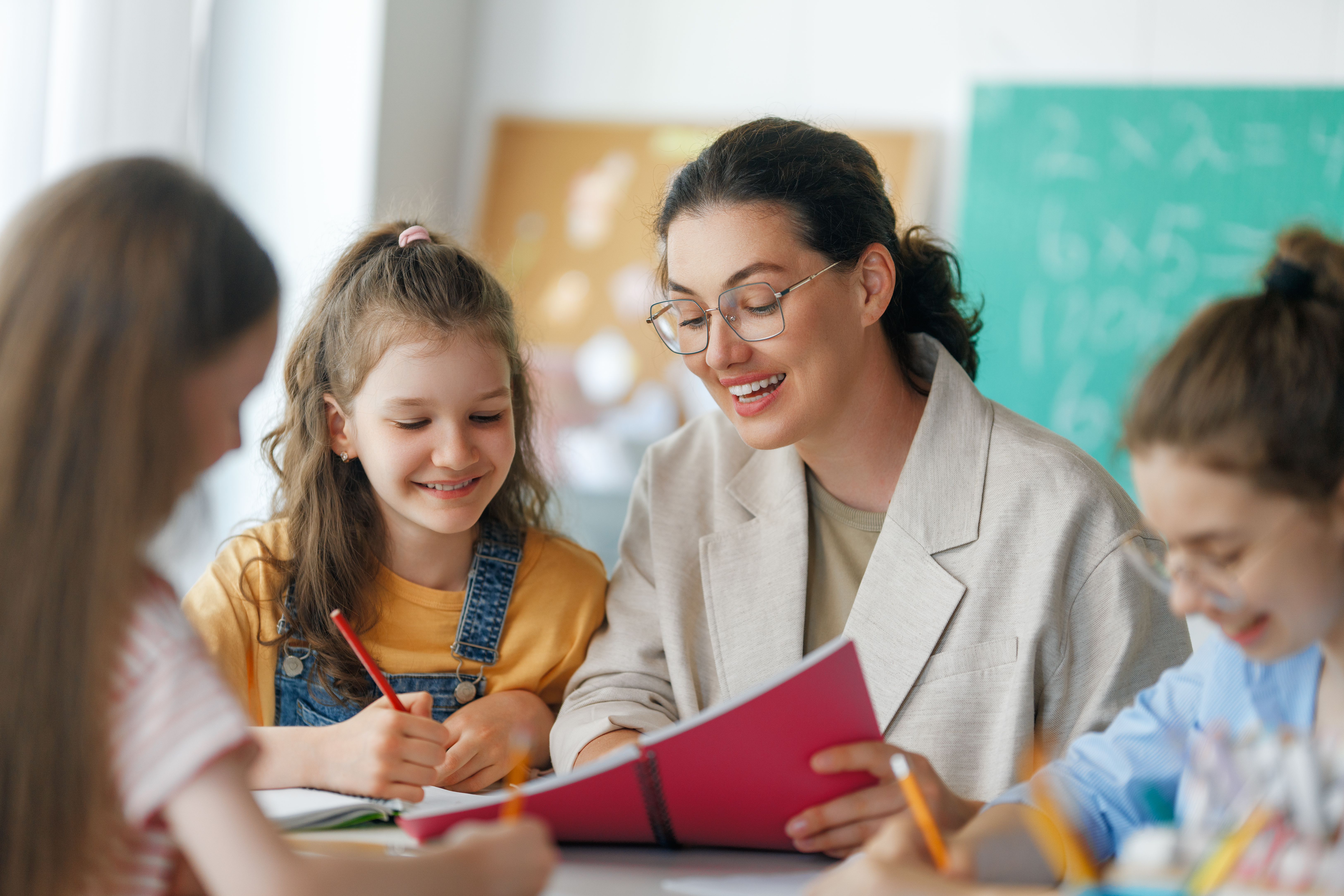 A teacher works with a student in the classroom