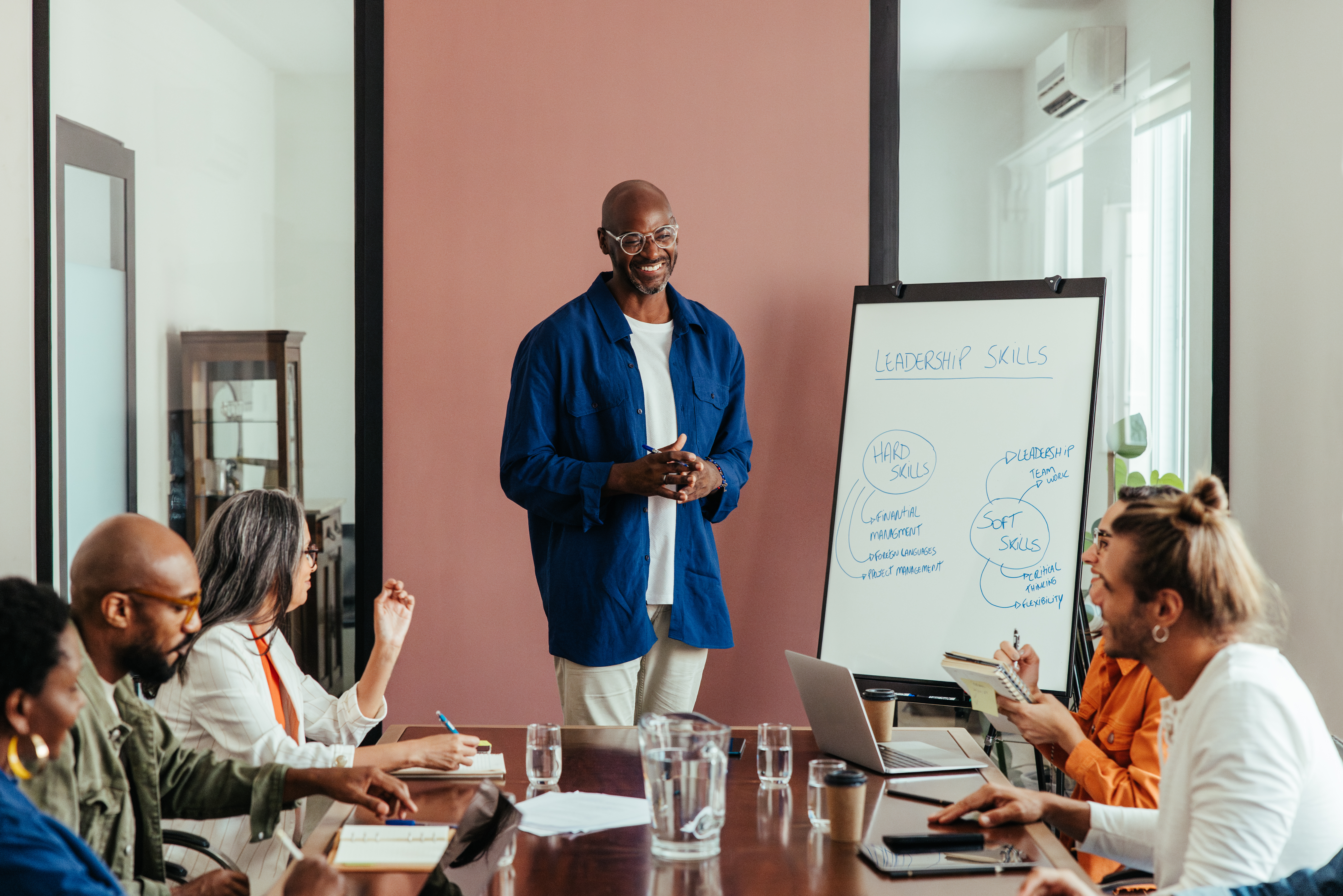Man leading a workshop with a diverse team.