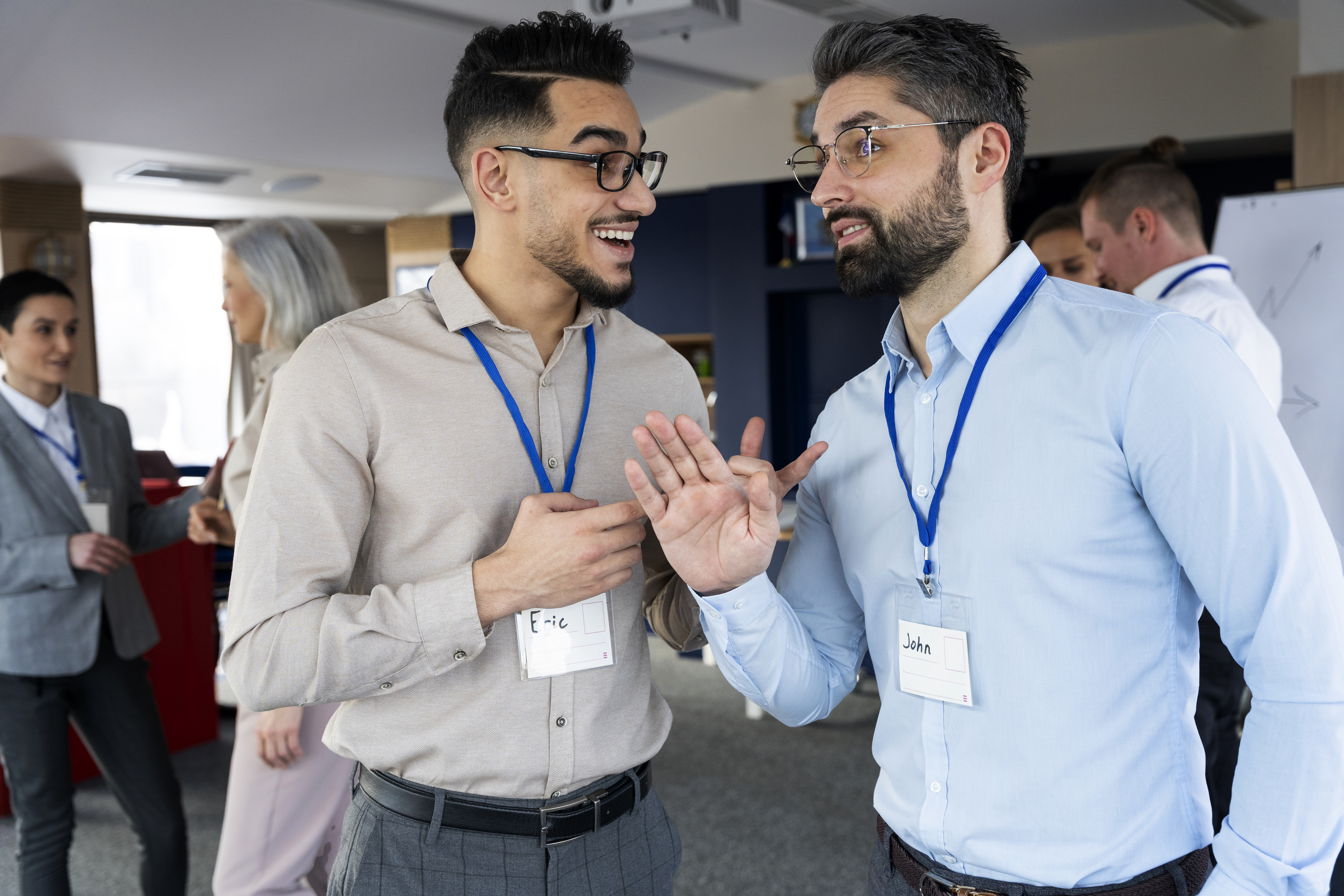 Two Latino men greet one another during a community partnership event.