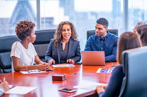 Businesspeople meet around a conference table
