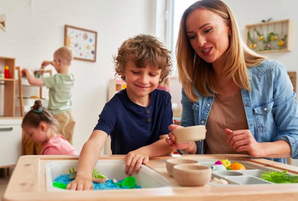 An educational therapist doing sensory exercises with a child.