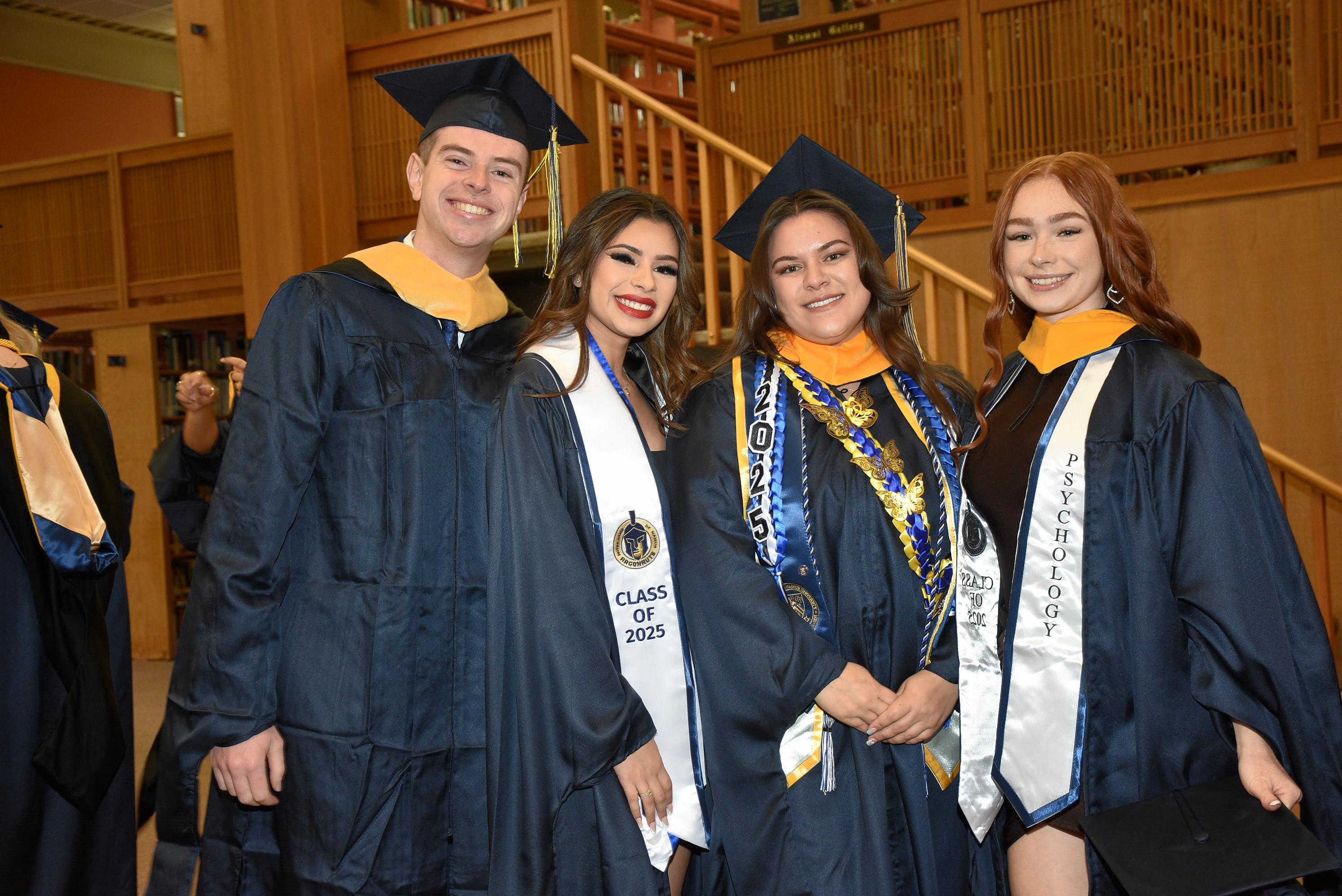 A diverse group of Notre Dame de Namur psychology graduates smile for the camera post graduation