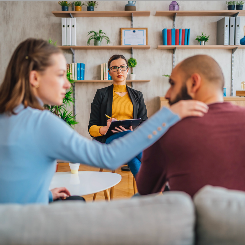 3 individuals sitting in a therapy session.