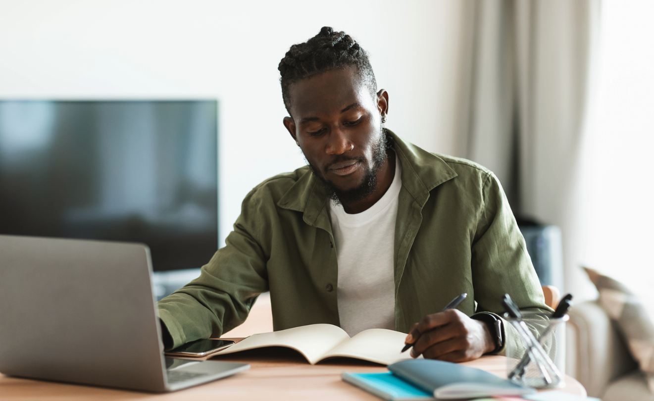 students in cap and gowns standing at graduation